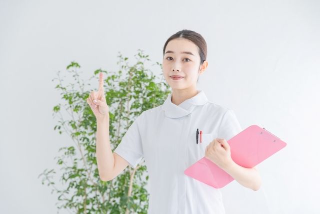 バインダーを持つ白衣の女性